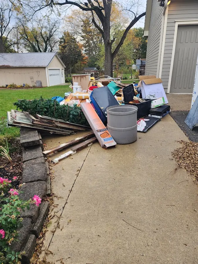 Dumpster being loaded with debris for 12 Yard Dumpster Rental in Greenville